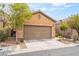Charming single-story home featuring a two-car garage and well-maintained desert landscaping in front at 8942 Partridge Hill St, Las Vegas, NV 89148