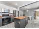 Modern kitchen features stainless steel appliances and a breakfast bar that seamlessly connects to the dining area at 8942 Partridge Hill St, Las Vegas, NV 89148