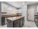 Bright kitchen showcasing a center island, stainless steel appliances, and white cabinets for a clean and modern look at 8942 Partridge Hill St, Las Vegas, NV 89148