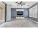This living room offers a ceiling fan, tile floors, TV, sliding glass door, and a large window for natural light at 8942 Partridge Hill St, Las Vegas, NV 89148