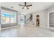 Open concept living room boasts tile flooring, stairs, recessed lighting and backyard views through the window at 8942 Partridge Hill St, Las Vegas, NV 89148