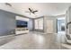 Open living room features neutral tones, tile flooring, ceiling fan, recessed lighting and a modern entertainment center at 8942 Partridge Hill St, Las Vegas, NV 89148