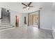 Well-lit open concept living room featuring stairs, tile floors, a sliding glass door and backyard access at 8942 Partridge Hill St, Las Vegas, NV 89148