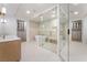 Well-lit bathroom with double vanities, soaking tub, and glass shower offers a spa-like retreat at 9101 Alta Dr # 207, Las Vegas, NV 89145