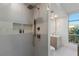 Modern bathroom featuring a glass-enclosed shower with sleek fixtures and a view through the window at 9101 Alta Dr # 207, Las Vegas, NV 89145