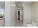 Hallway view to a modern bathroom with a shower and sleek vanity at 9101 Alta Dr # 207, Las Vegas, NV 89145
