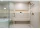 Modern bathroom with glass shower, built-in bench, and tub combines luxury with functionality at 9101 Alta Dr # 207, Las Vegas, NV 89145