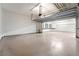 Spacious garage with sealed concrete flooring, overhead door openers and storage on side wall at 9101 Alta Dr # 207, Las Vegas, NV 89145