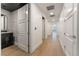 Hallway with hardwood floors, white trim, and recessed lighting leading to various rooms with white doors at 9101 Alta Dr # 207, Las Vegas, NV 89145