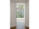 Hallway leads to a bright room with a window view of trees and a building with a red-tiled roof at 9101 Alta Dr # 207, Las Vegas, NV 89145