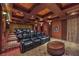Luxurious home theater with plush leather seating, a large screen projector, and custom lighting for an immersive experience at 9101 Alta Dr # 207, Las Vegas, NV 89145
