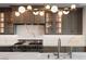 Gourmet kitchen featuring a large island, stainless steel appliances, custom cabinets, and modern lighting at 9101 Alta Dr # 207, Las Vegas, NV 89145