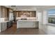 Gourmet kitchen with stone countertops, stainless steel appliances, custom cabinetry, and an adjacent dining area at 9101 Alta Dr # 207, Las Vegas, NV 89145