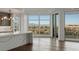Modern kitchen adjacent to an open room with floor to ceiling windows offering panoramic city and mountain views at 9101 Alta Dr # 207, Las Vegas, NV 89145