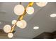 Modern kitchen lighting fixture with orb-shaped bulbs over kitchen island at 9101 Alta Dr # 207, Las Vegas, NV 89145
