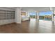 Bright open-concept living space with wood floors, built-in shelving, and a modern kitchen with scenic city views at 9101 Alta Dr # 207, Las Vegas, NV 89145