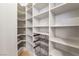 Spacious walk-in pantry with custom shelving and storage baskets offers plentiful organization at 9101 Alta Dr # 207, Las Vegas, NV 89145