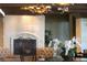 Cozy sitting area with a stone fireplace, tufted chairs, and stylish lighting at 9101 Alta Dr # 207, Las Vegas, NV 89145