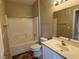 Bright bathroom with a large mirror, a shower-tub combo, and a white vanity sink at 9470 Peace Way # 233, Las Vegas, NV 89147