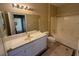 Well-lit bathroom with a bathtub-shower, large mirror, and a white vanity sink at 9470 Peace Way # 233, Las Vegas, NV 89147
