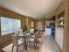 Bright dining area with tile floors and a modern glass dining table set for six at 9470 Peace Way # 233, Las Vegas, NV 89147