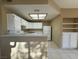 Open concept kitchen with white cabinets and breakfast bar provides a seamless flow for entertaining at 9470 Peace Way # 233, Las Vegas, NV 89147