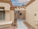 Inviting property entrance with tiled walkway and covered porch, enhanced by desert landscaping at 9533 Yucca Blossom Dr, Las Vegas, NV 89134