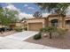 Attractive home with a two-car garage, desert landscaping, and mature trees shading the front at 9533 Yucca Blossom Dr, Las Vegas, NV 89134