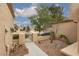 Pathway leading to a private courtyard with decorative landscaping and a secure gate at 9533 Yucca Blossom Dr, Las Vegas, NV 89134