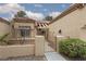 View of the property's gated courtyard with desert landscaping and a tiled roof at 9533 Yucca Blossom Dr, Las Vegas, NV 89134