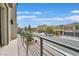 Balcony view overlooking the street with neatly landscaped homes and blue skies at 9830 Wild Coyote Ct, Las Vegas, NV 89141