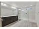 Modern bathroom features a spacious glass shower, gray wood tile, and dual sink vanity with modern fixtures at 9830 Wild Coyote Ct, Las Vegas, NV 89141