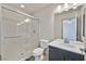 Bathroom featuring a glass-enclosed shower, wood-look tile flooring, and marble-look vanity at 9830 Wild Coyote Ct, Las Vegas, NV 89141