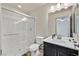 Modern bathroom with a glass-enclosed shower, toilet, and single sink vanity with marble countertop at 9830 Wild Coyote Ct, Las Vegas, NV 89141