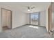 Bedroom features neutral carpet, natural light from a large window, and access to a walk-in closet at 9830 Wild Coyote Ct, Las Vegas, NV 89141