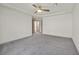A large, open bedroom with carpet, fan, and natural light at 9830 Wild Coyote Ct, Las Vegas, NV 89141