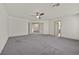 Neutral bedroom with a ceiling fan and access to other areas of the home at 9830 Wild Coyote Ct, Las Vegas, NV 89141