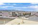 Rooftop view showing a neighborhood with mountain backdrop; showcasing location and community appeal under a blue sky at 9830 Wild Coyote Ct, Las Vegas, NV 89141