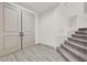 Bright foyer with light gray wood-look floors, staircase, and a double door entry at 9830 Wild Coyote Ct, Las Vegas, NV 89141
