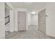 Inviting hallway with modern wood-look tile flooring and neutral paint palette at 9830 Wild Coyote Ct, Las Vegas, NV 89141