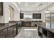 Beautiful kitchen with stainless steel appliances, granite countertops, dark wood cabinets and wood-look tile flooring at 9830 Wild Coyote Ct, Las Vegas, NV 89141