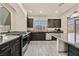 Modern kitchen features stainless steel appliances, granite countertops, and wood-style flooring at 9830 Wild Coyote Ct, Las Vegas, NV 89141