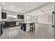 Modern kitchen with granite counters, dark wood cabinets, stainless steel appliances and large island with seating at 9830 Wild Coyote Ct, Las Vegas, NV 89141