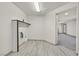 Laundry room with wood-look tile flooring, shelf, and modern hookups at 9830 Wild Coyote Ct, Las Vegas, NV 89141