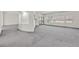 Large upstairs living area with gray carpet, access to a balcony, and neutral walls at 9830 Wild Coyote Ct, Las Vegas, NV 89141