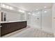 Spa-like main bathroom with dual sinks, dark wood cabinets, and a frameless glass shower at 9830 Wild Coyote Ct, Las Vegas, NV 89141