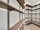 Walk-in pantry featuring custom shelving for optimal storage in this home at 9830 Wild Coyote Ct, Las Vegas, NV 89141