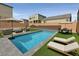 Backyard featuring a sparkling pool, lounge chairs, and an outdoor dining area at 9830 Wild Coyote Ct, Las Vegas, NV 89141