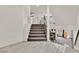 Bright and airy staircase with modern railings and a landing overlooking a spacious living area, perfect for a contemporary home design at 9830 Wild Coyote Ct, Las Vegas, NV 89141
