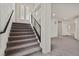 Carpeted staircase with modern railing and abundant natural light at 9830 Wild Coyote Ct, Las Vegas, NV 89141